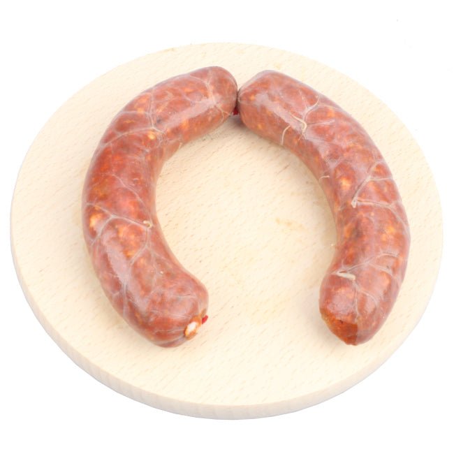 Salsiccia fresca di Corleto Perticara realizzata con carne di suini allevati localmente, lavorata artigianalmente e condita con sale, macinato di peperoni e sale tipici della tradizione gastronomica lucana.